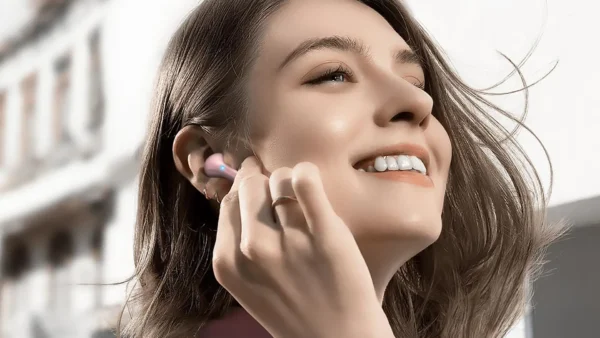 ktgee bluetooth 5.3 wireless earbuds in pink shown worn in-ear by happy woman qtooth-review