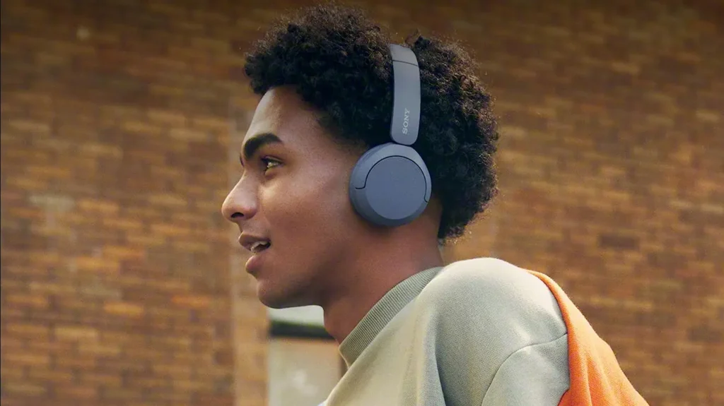 Young man commuting while using the Sony WH CH520 Bluetooth Wireless Headset as part of QTOOTH's review