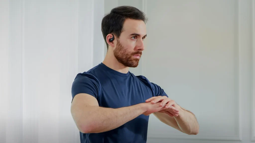Shows man wearing of the Shokz OpenFit Bluetooth Headphones in black while exercising