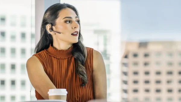 poly 5200 plantronics 5200 bluetooth headset review showing woman wearing device in office setting