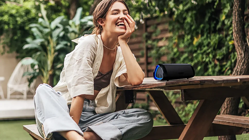 woman enjoying using bolabutty x-go portable bluetooth speaker review